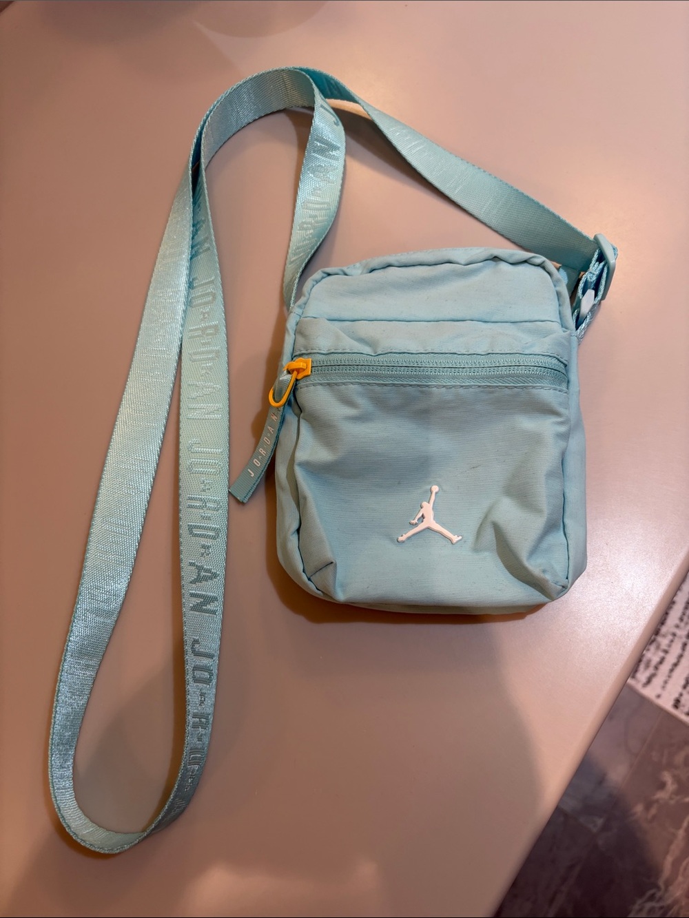 Jordan Teal Mini Crossbody Bag with Yellow Zipper Accent. Canvas. Adjust strap.
